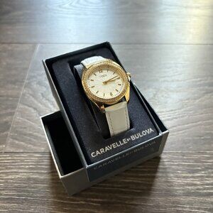 NTOW Caravelle By Bulova Women’s Watch Gold Gemmed Bezel White Leather Band S/M
